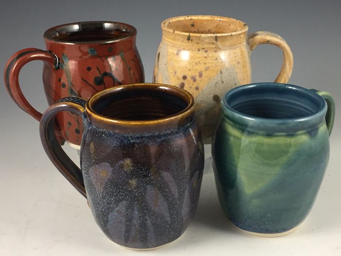 Handmade functional ceramic mugs, wheel-thrown of white stoneware clay and high fired.  