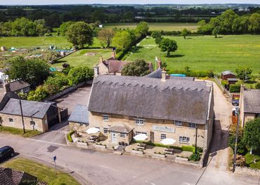 A scenic rural village with traditional thatched cottages.