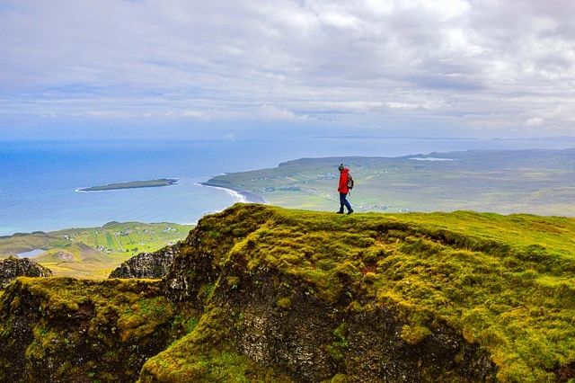 Solo Man in a red jacket hiking in Scotland