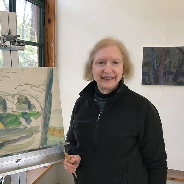 Photograph of Helaine in front of Acrylic painting in her studio at Weir Farm CT