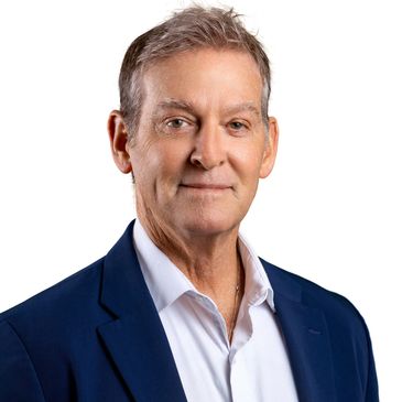 Professional headshot of a middle-aged man in a suit.