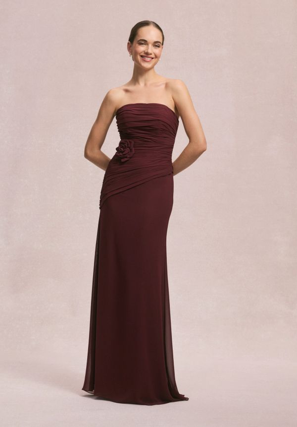 Woman in a strapless maroon evening gown.