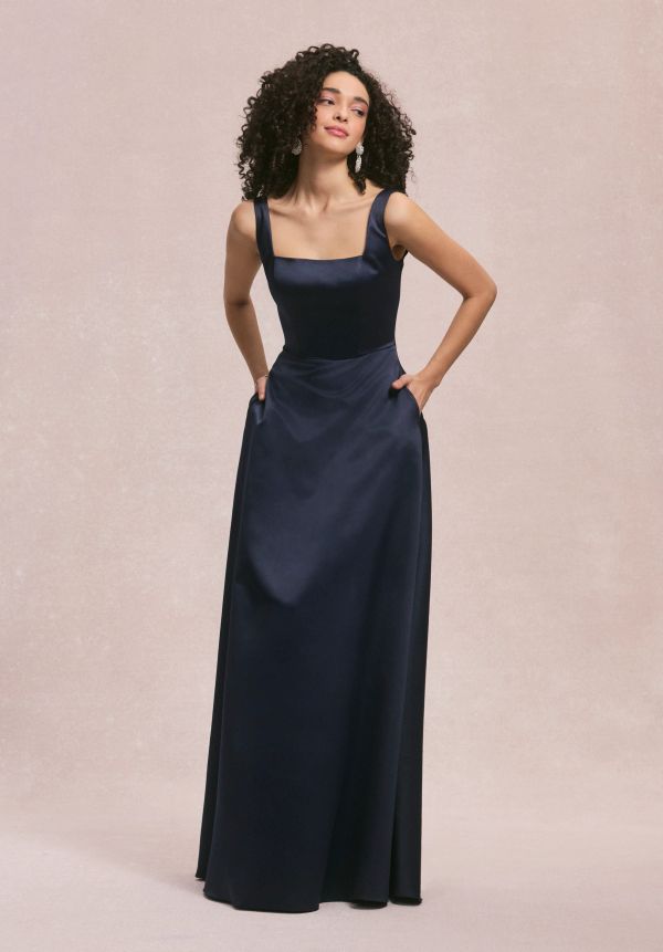 Woman in a navy blue satin evening gown.