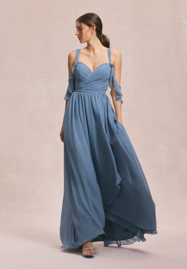 Woman in a flowing blue evening gown.