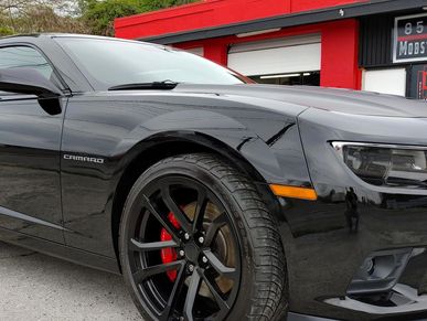 A photo of a black camero sitting in front of the Mobster Auto Detail shop in Bristol, Virginia.