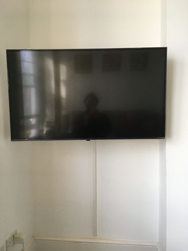 TV mounted into cement wall