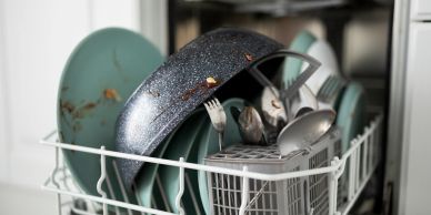 Clean dishes drying in a dishwasher rack.