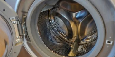 Open front-load washing machine drum.
