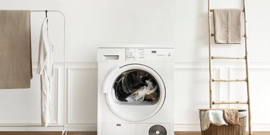 White washing machine in a minimalistic laundry room.