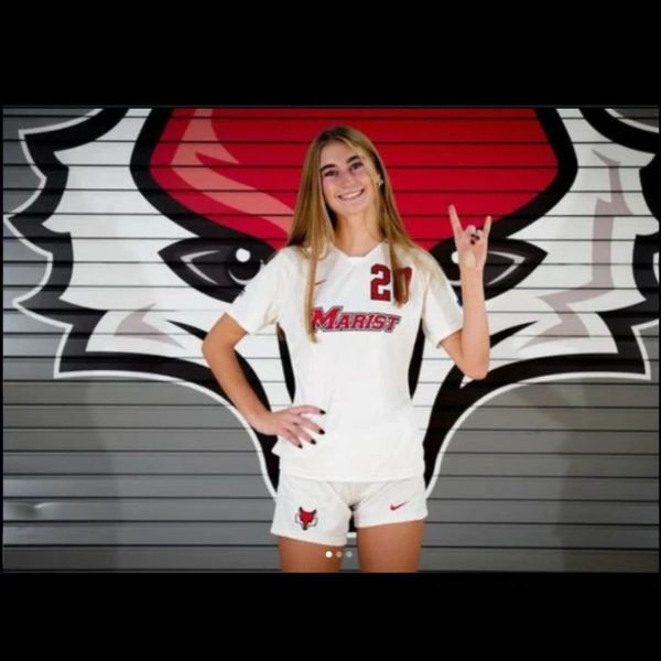 Female soccer player in Marist uniform posing with a hand gesture.