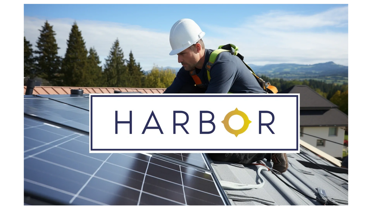 A technician installing solar panels on a roof with the Harbor Solar logo on top 