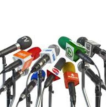 A cluster of microphones from various media outlets.