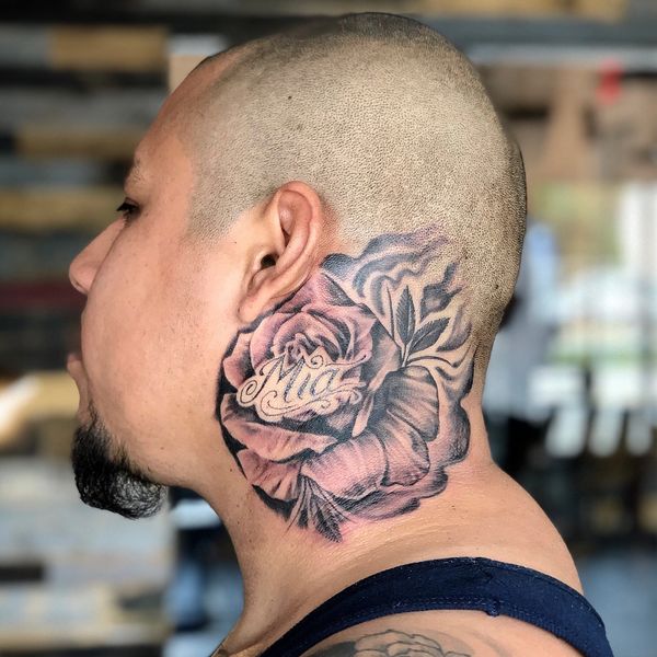 rose tattoo on the neck