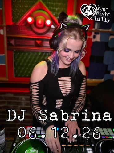 DJ Sabrina performing at Emo Night Philly with cat ear headphones and a stylish cut-out top.