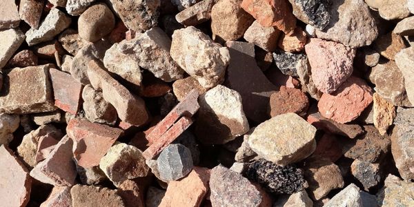 Close-up of various small rocks and gravel with different textures and colors.