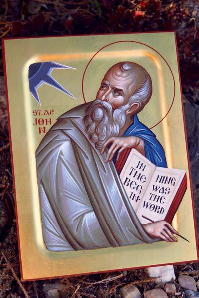 Icon of St. John holding a book with a dove above him.
