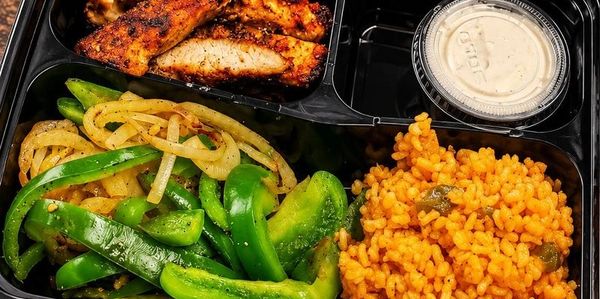 CEK fajita chicken meal prep box with grilled onions, sweet peppers and Spanish rice