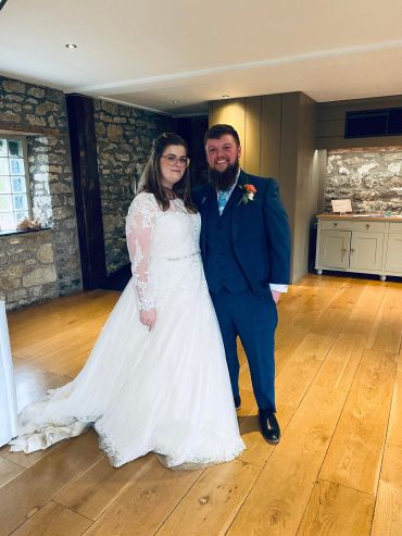 Bride and groom posing indoors on their wedding day.