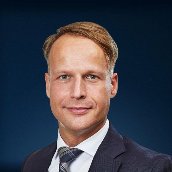 Professional man in suit against a blue background.
