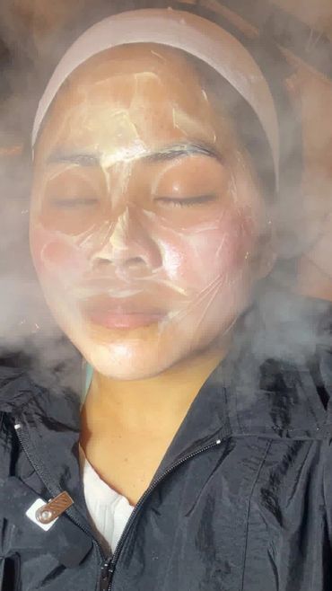 Person enjoying a facial steam treatment with eyes closed.
