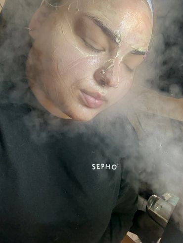 Person with a facial mask enjoying a steam treatment.