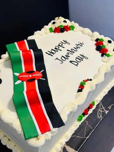 White cake decorated with Kenyan flag and "Happy Jamhuri Day" message.
