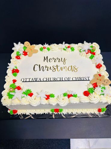 Christmas cake decorated with festive icing and gingerbread men.