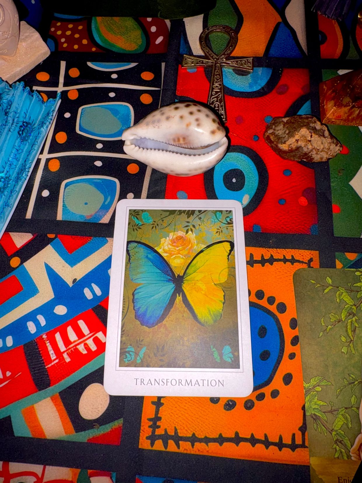 Colorful tarot card reading setup with 'Transformation' card.