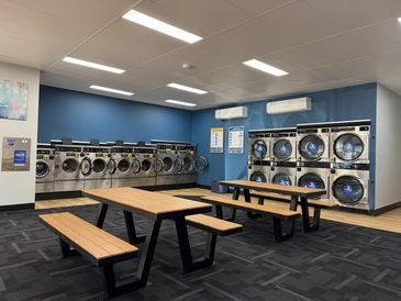 Clean fresh comfortable space for guests to do their laundry.