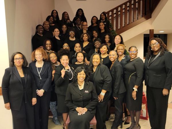 The members of the Omega Psi Omega chapter posing at a staircase