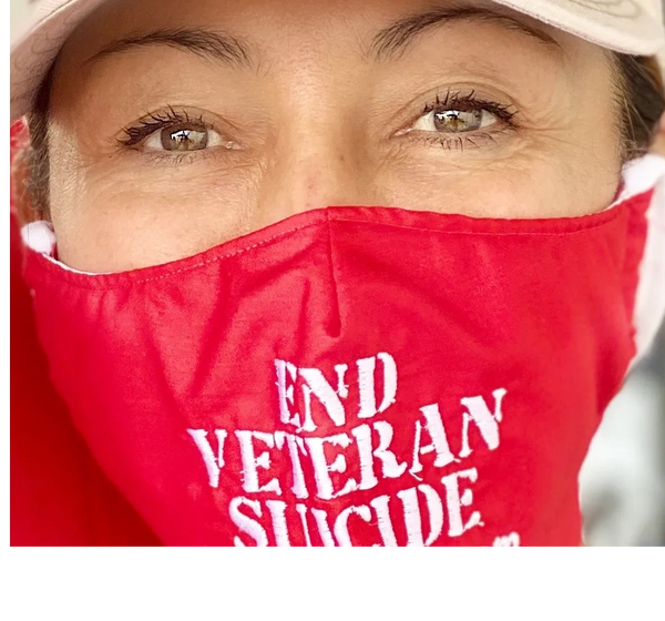 Someone wearing a mask that says End Veteran Suicide