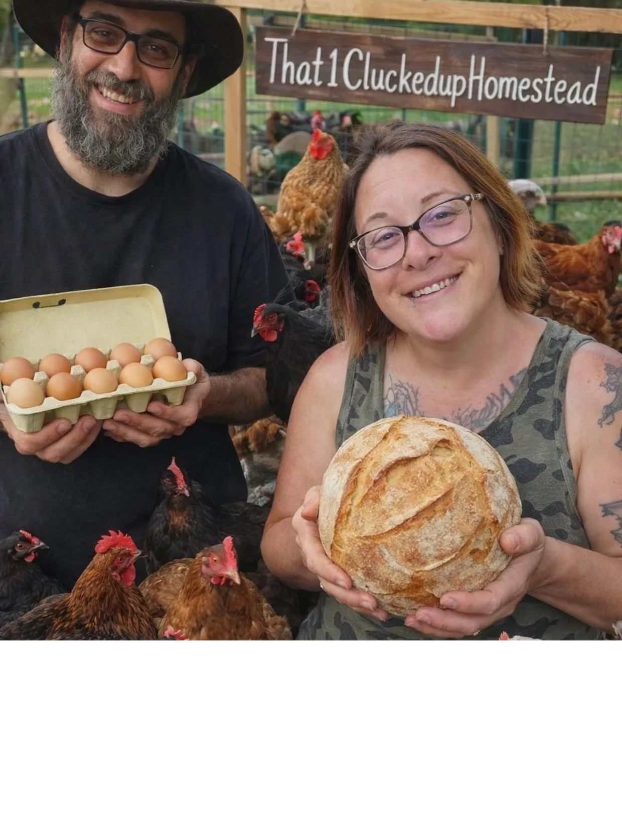 Two happy people holding fresh eggs and bread on a farm with chickens.