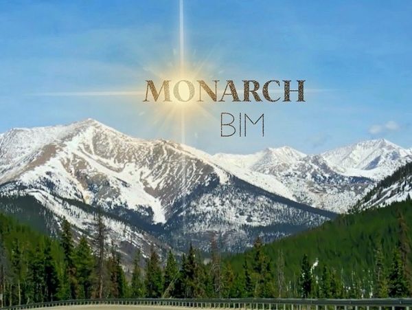 Snow-capped mountains under a clear blue sky with 'Monarch BIM' text.