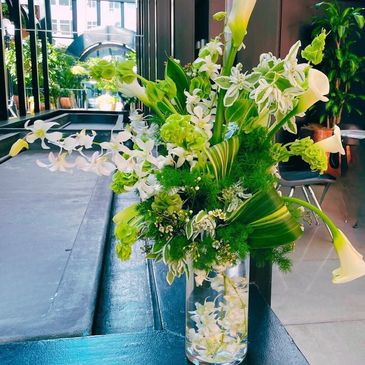 seattle court in the square arch large cala lily arrangement , bells of ireland, euphorbia, orchids 