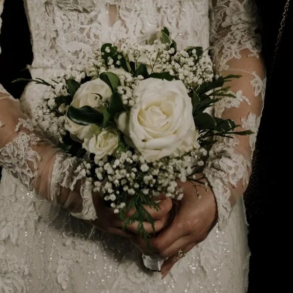 small white rose bridal bouquet with babys breath, variegated pitt with lace wedding dress