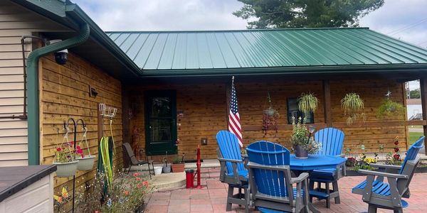 Cozy patio with blue chairs and American flag.