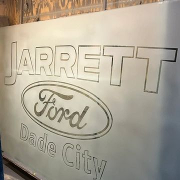 Outline of a sign reading 'Jarrett Ford Dade City' on a wall.