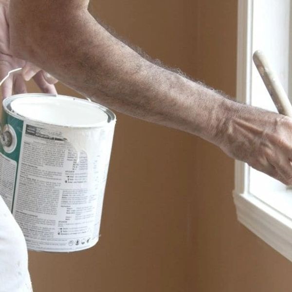 Professional painter taping and prepping surfaces for flawless paint application in Port Orange.