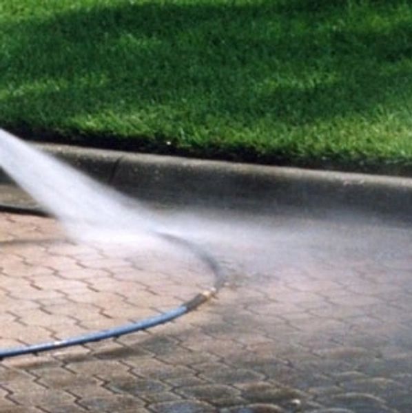 Before and after comparison of a pressure-washed driveway in New Smyrna Beach.