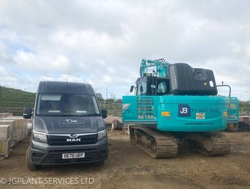 JG Plant's service van parked along side a 13t digger with engine bonnet open to facilitate repairs.