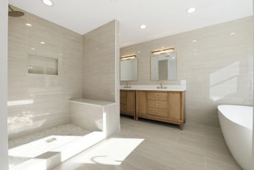 Modern bathroom with shower, double vanity, and bathtub.