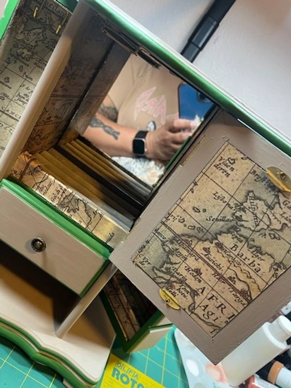 Wooden jewelry box with vintage map design and mirrored interior.