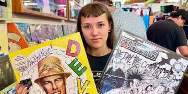 Women holding two vinyl records.