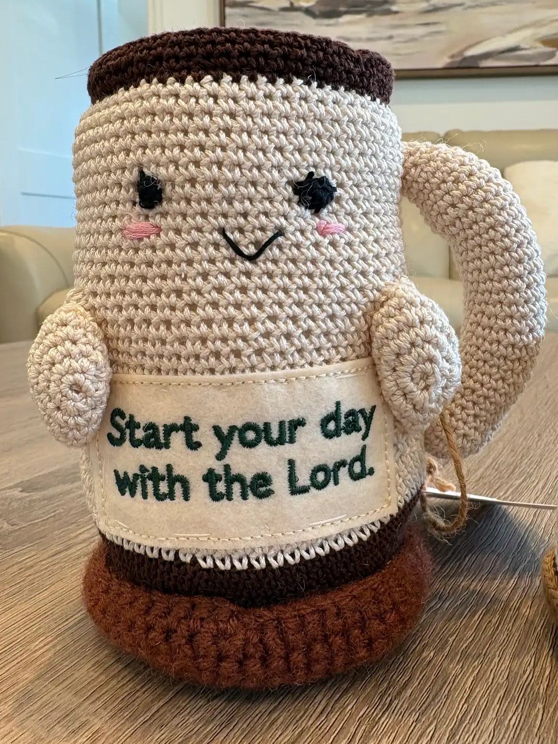 Crocheted coffee cup with smile and inspirational message.