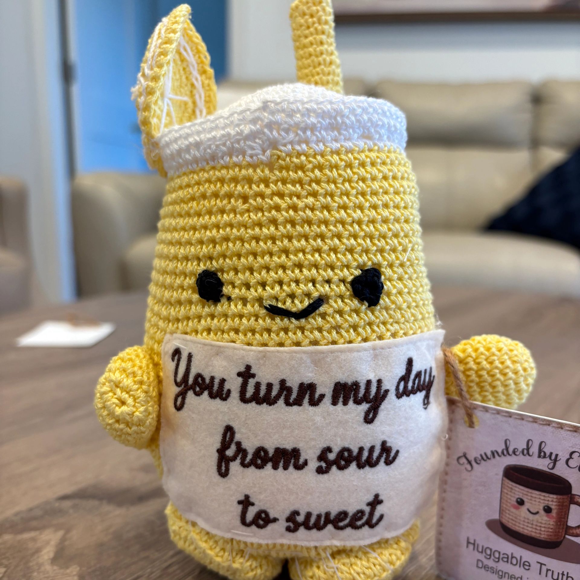 Yellow crochet character with a sweet message.