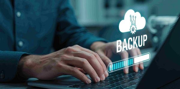Person typing on laptop with a digital backup progress bar.