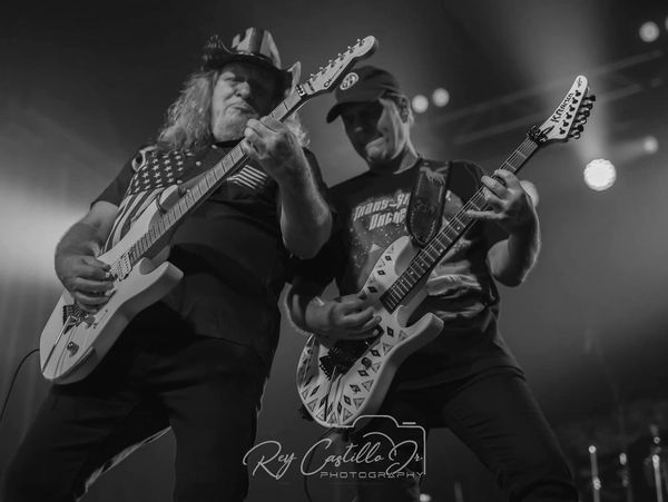Two men playing electric guitars