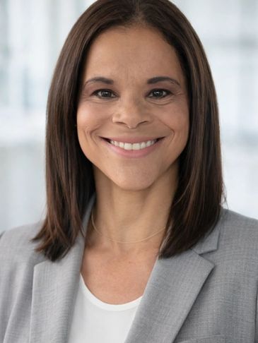 Confident woman smiling in a professional setting.