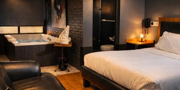 Cozy hotel room with a jacuzzi tub and modern decor.