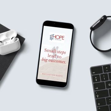 Smartphone displaying a motivational quote with earbuds, a watch, and keyboard around it.